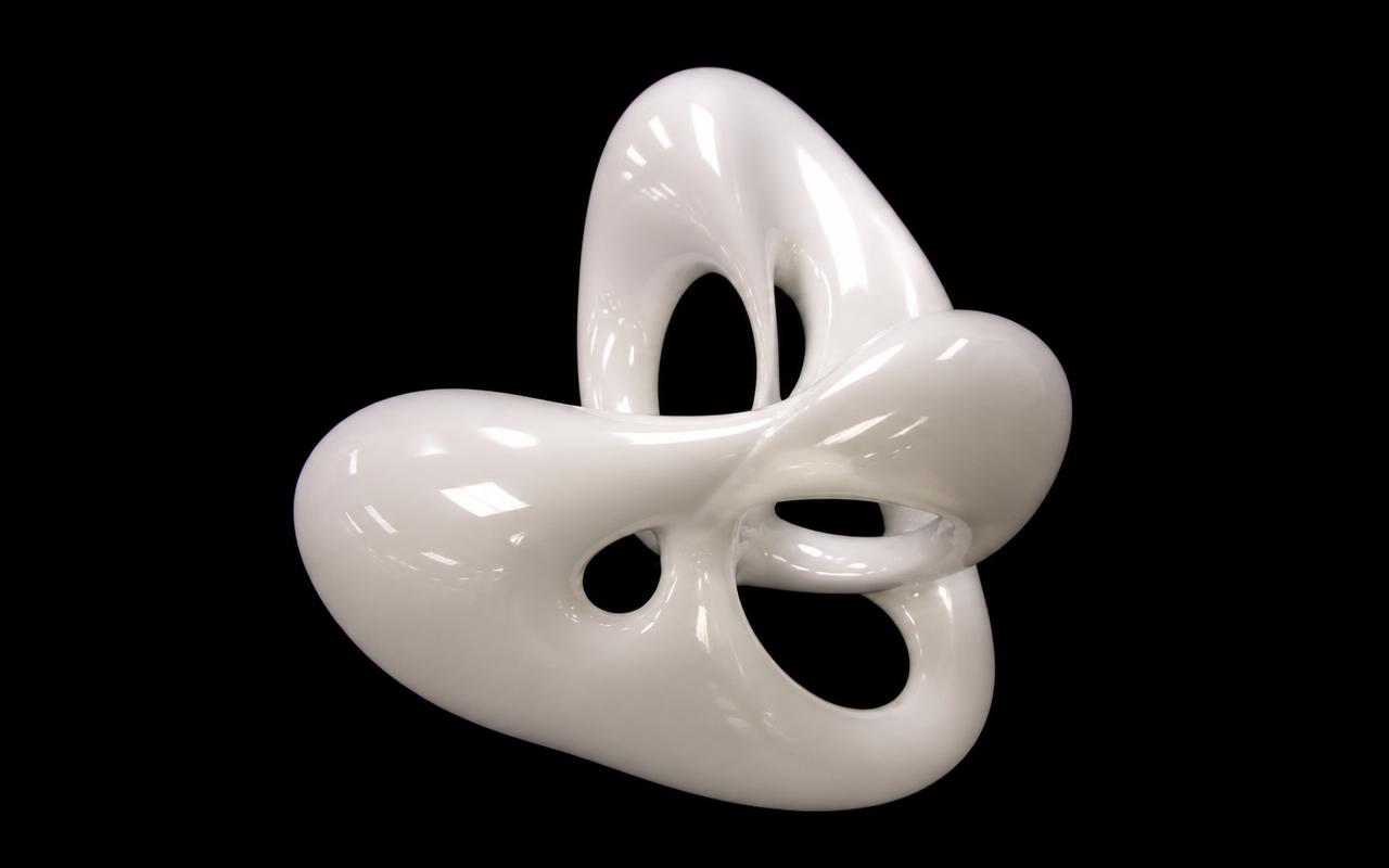 Discarded frame: a glossy white sculpture shot dry on black with hard studio reflections