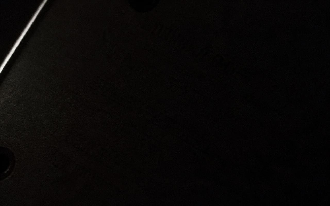 Discarded frame: an almost black close-up where the etching is illegible