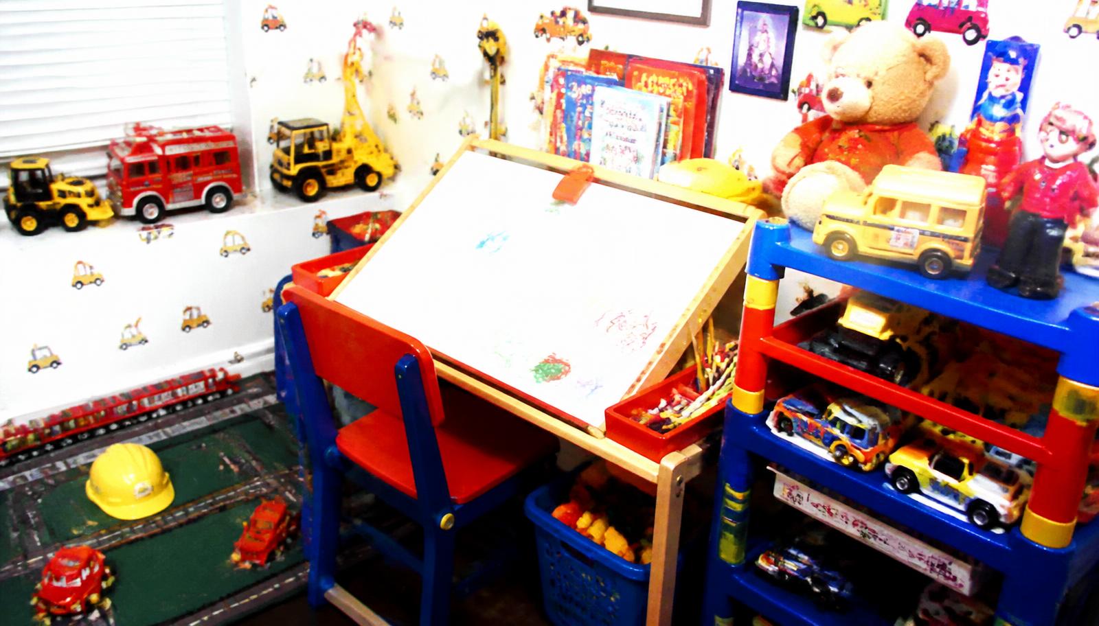 Discarded frame: a cluttered playroom in saturated primary colours