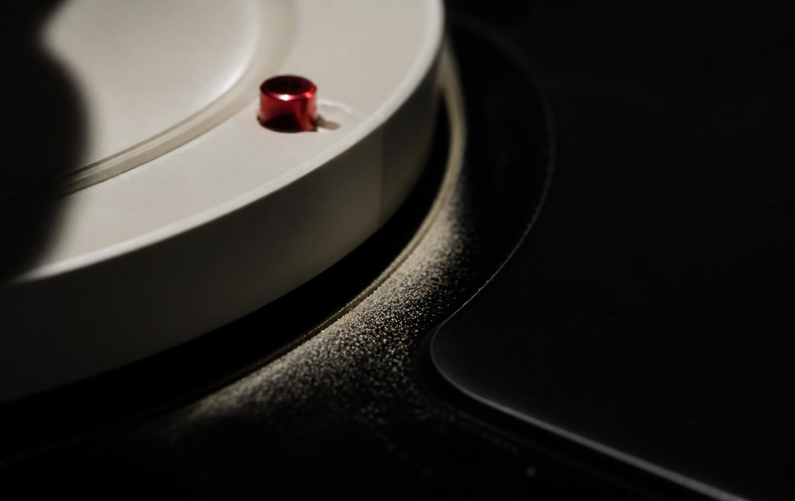 Macro of the disc edge with pale dust pushed into a crescent by an almost invisible rotation