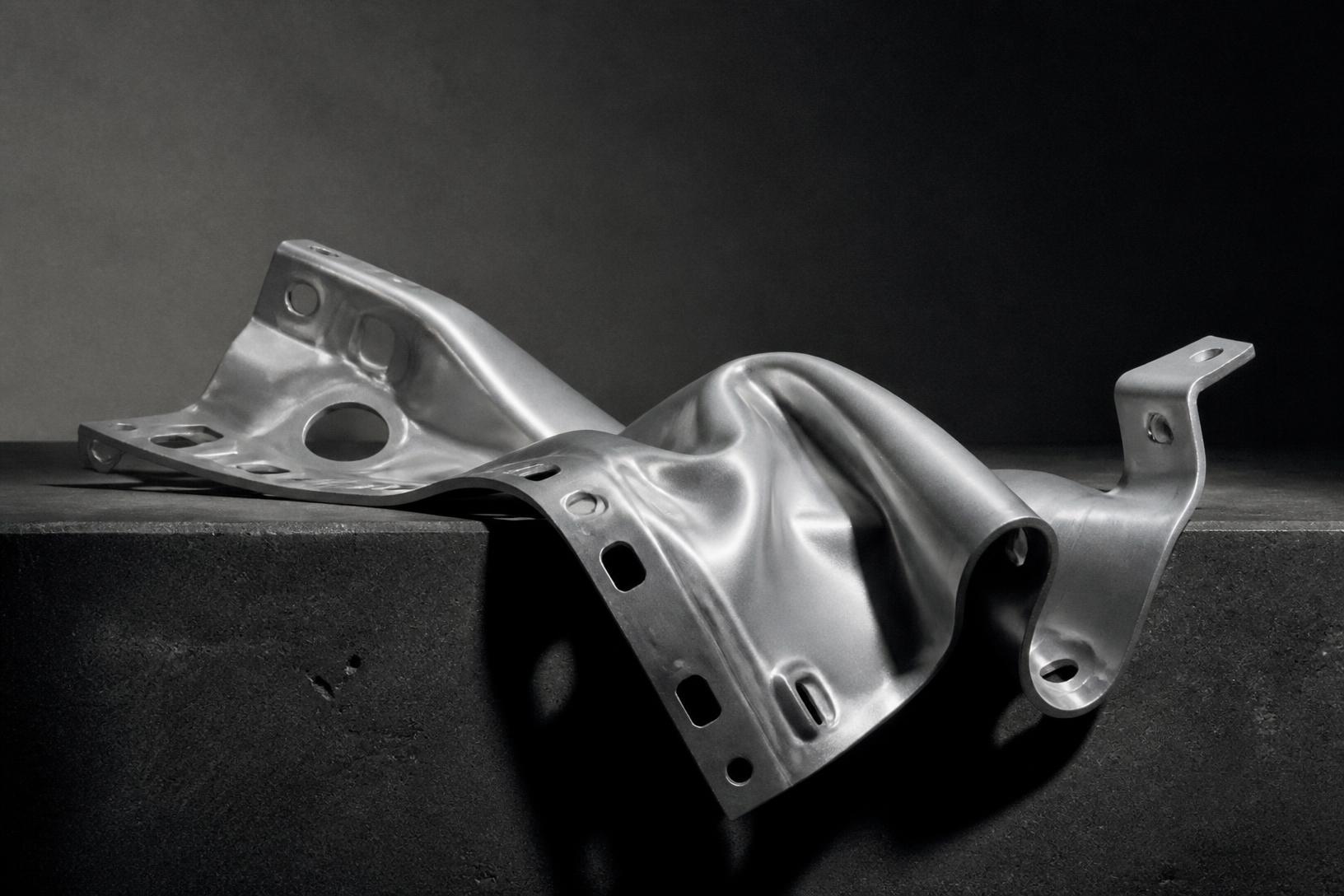A machined aluminium bracket folding like heavy cloth