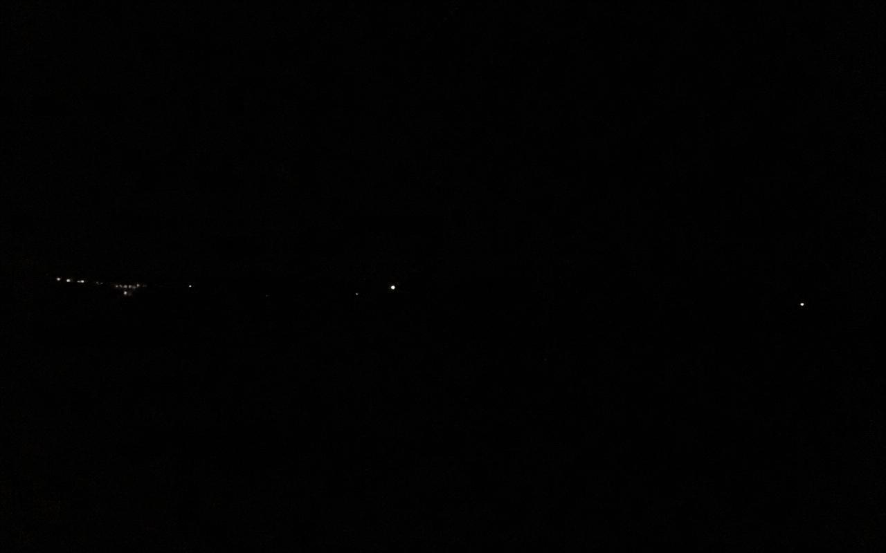 Discarded frame: an almost entirely black night image with a few distant lights