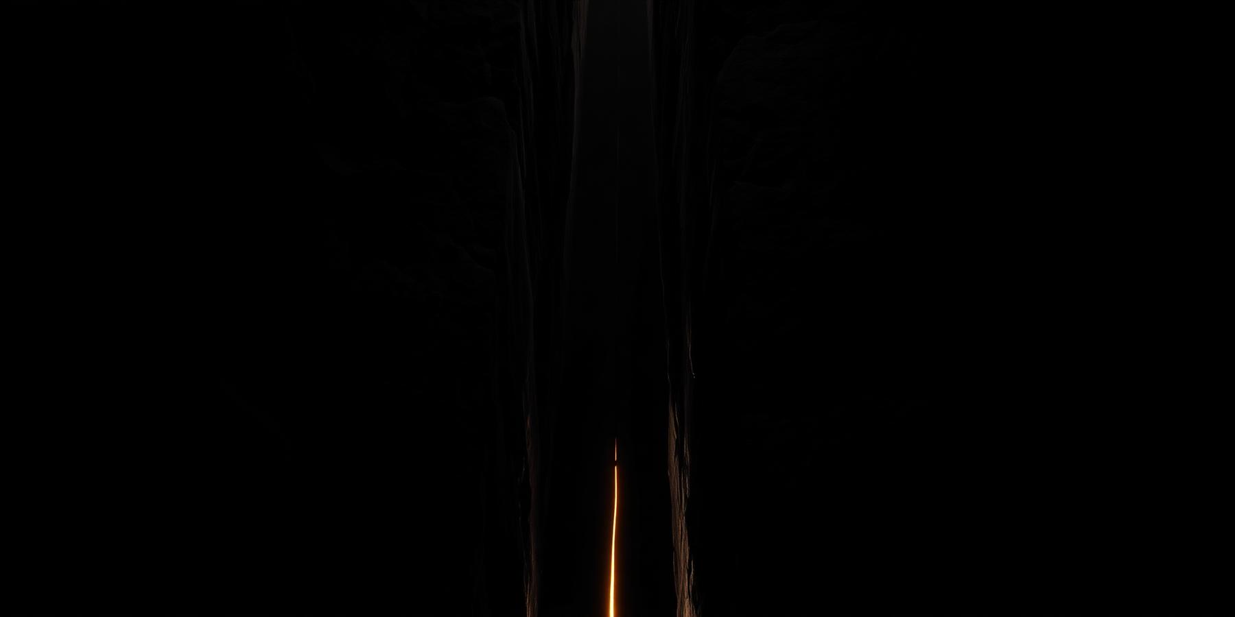 Monolithic dark forms separated by a narrow lit gap